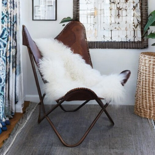 Faux Sheepskin Rug draped on chair in dark boho styled room