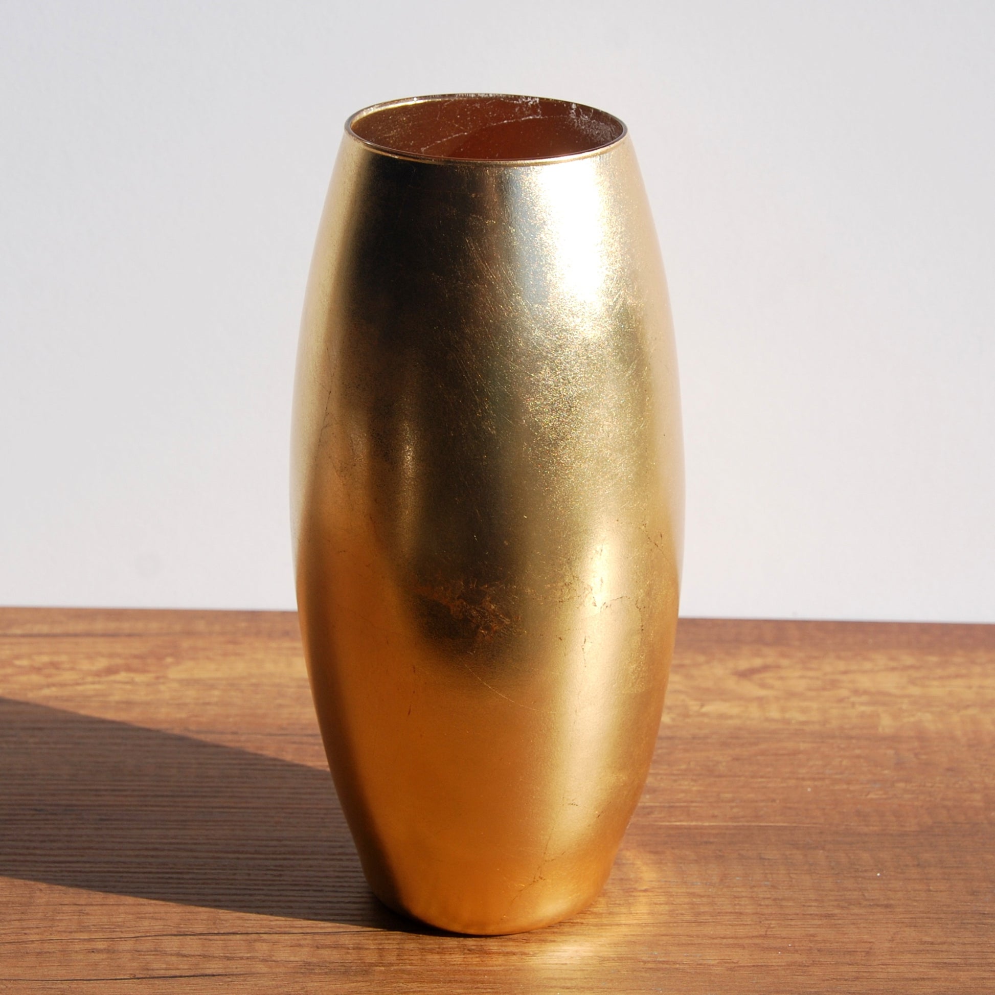 gold flower vase on table