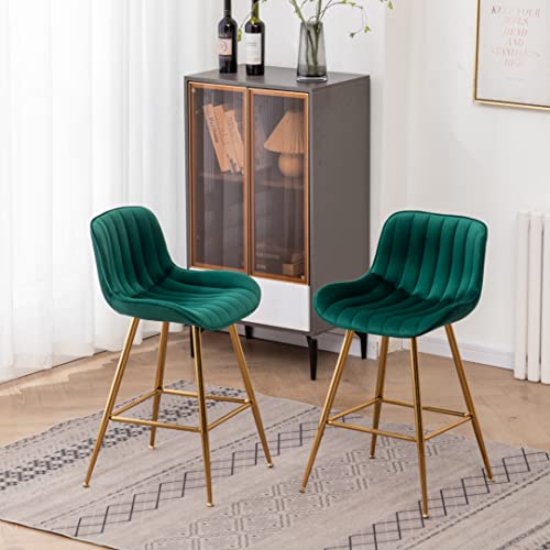 Green Velvet Bar Stools with golden legs placed in a room