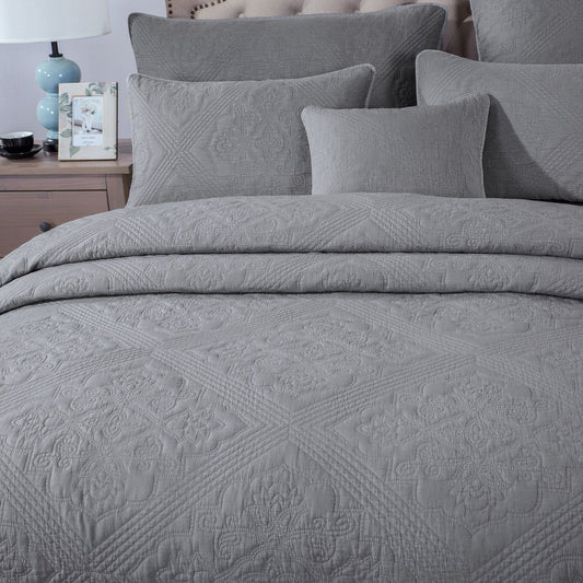 close up of gray matelasse quilt bedspread and pillow covers